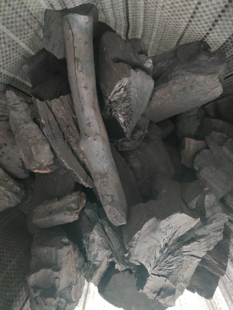 Charcoal inside a woven sack